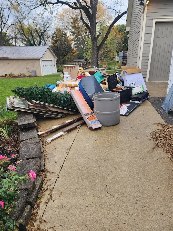 Dumpster being loaded with debris for Commercial Dumpster Rental in Clayton